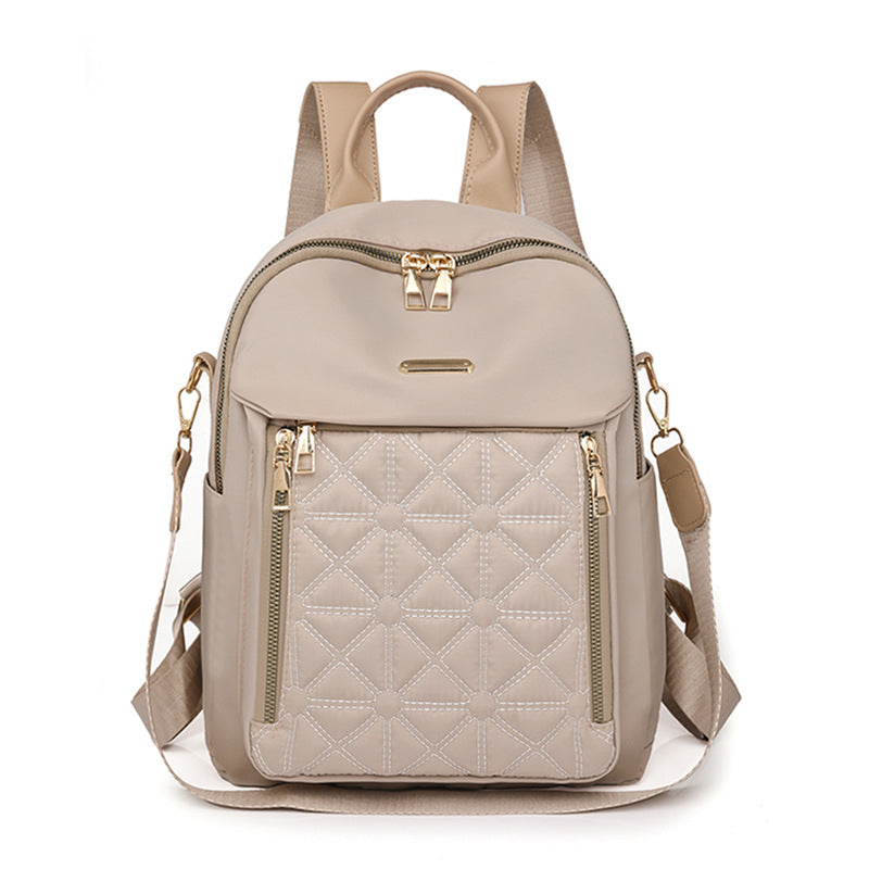 Chic women's quilted fashion backpack, a multi-compartment shoulder bag offering elegant style & practical storage.