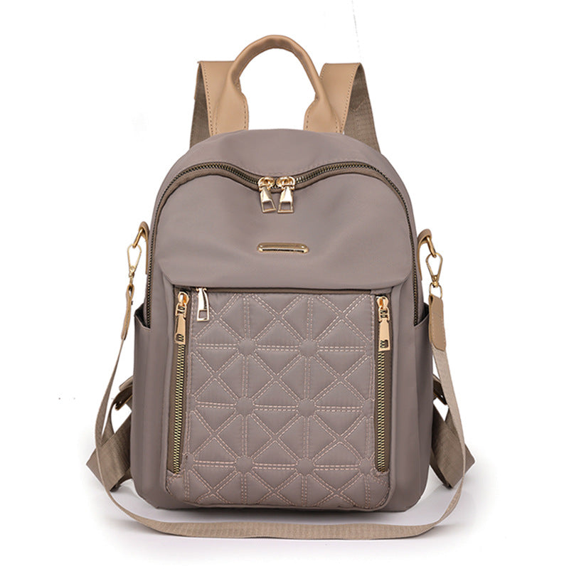 Practical multi-compartment women's quilted backpack, perfect for organizing school supplies, work items, or travel gear.