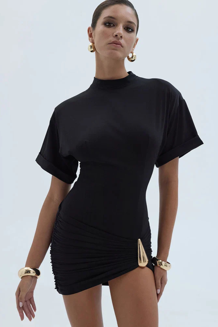 Fitted women's black ruched bodycon mini dress. Elegant short evening wear for special occasions.