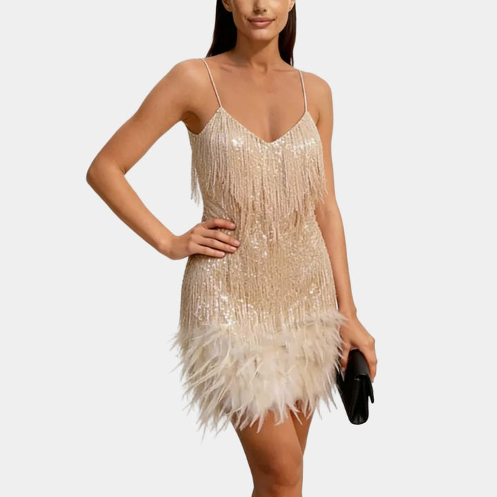 Trendy mini dress with a sequin overlay and dramatic feather trim.