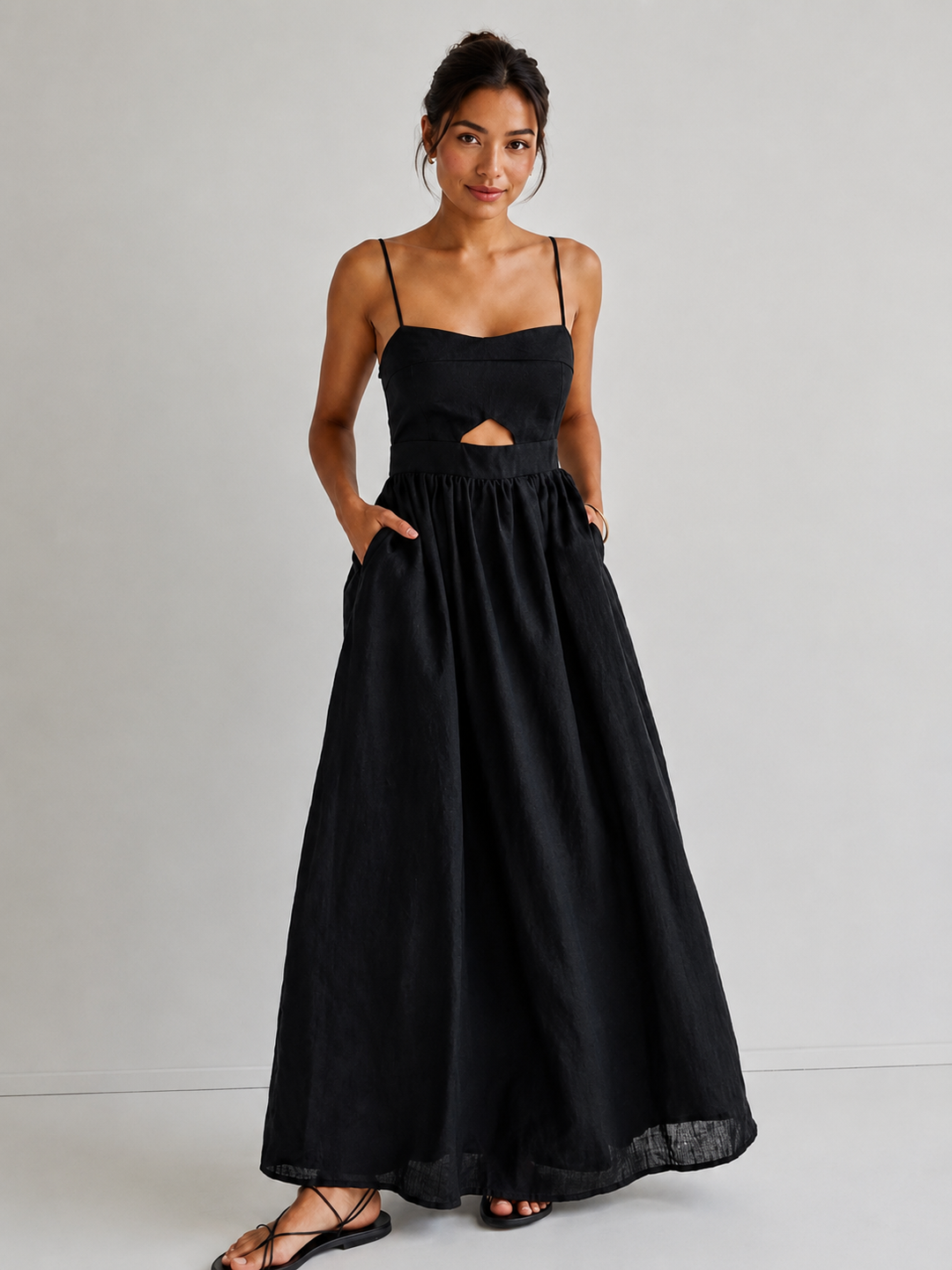 Women's black sleeveless midi dress with chic cutout & convenient pockets, ideal for elegant summer fashion.