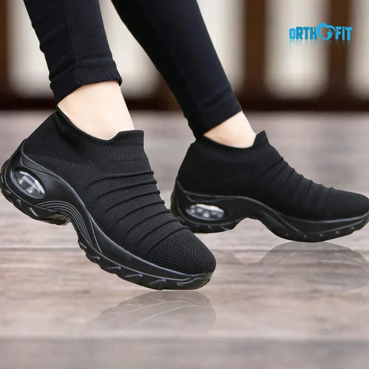Women's black slip-on sneakers with air-cushion sole for ultimate comfort & arch support.