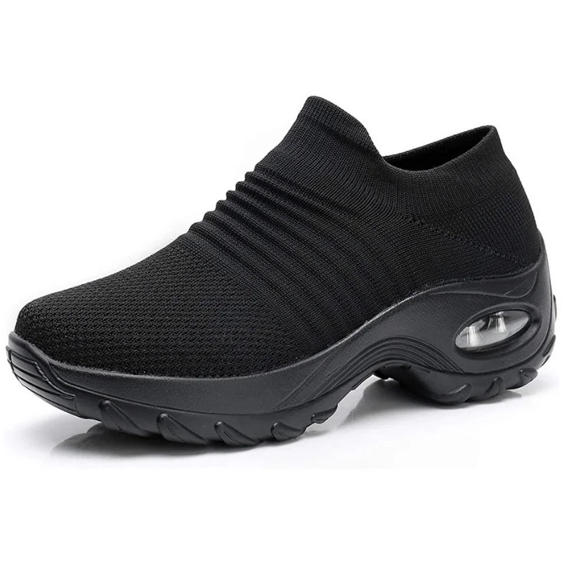 Comfortable women's slip-on sneakers in black, with supportive air-cushion sole & arch support.