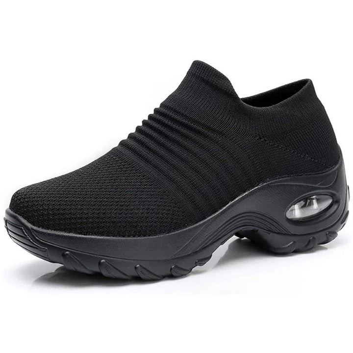 Comfortable women's slip-on sneakers in black, with supportive air-cushion sole & arch support.
