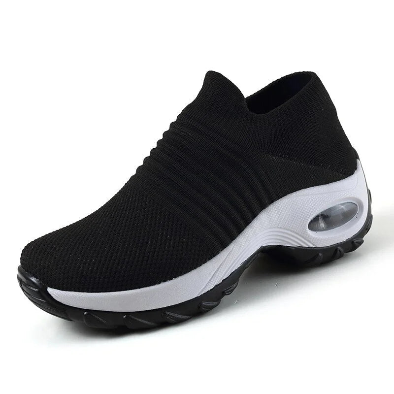 Women's black casual slip-on sneakers, cushioned sole, arch support, perfect for daily wear.