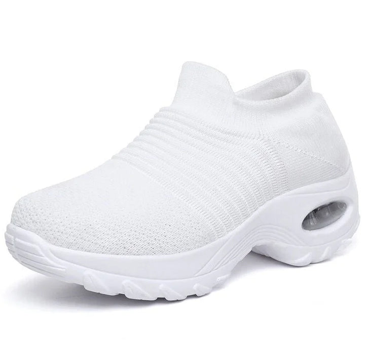 Supportive black slip-on sneakers for women, air-cushion sole, great for all-day comfort.