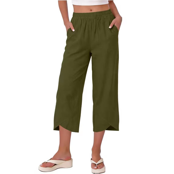 Woman walking in effortless wide leg stretch capri trousers, demonstrating comfort & style.