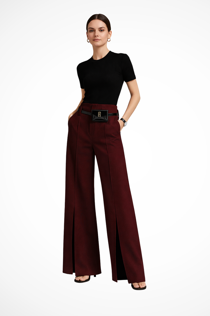 Full length model shot of women's black tailored wide leg trousers with a unique pouch belt, showing elegant movement.
