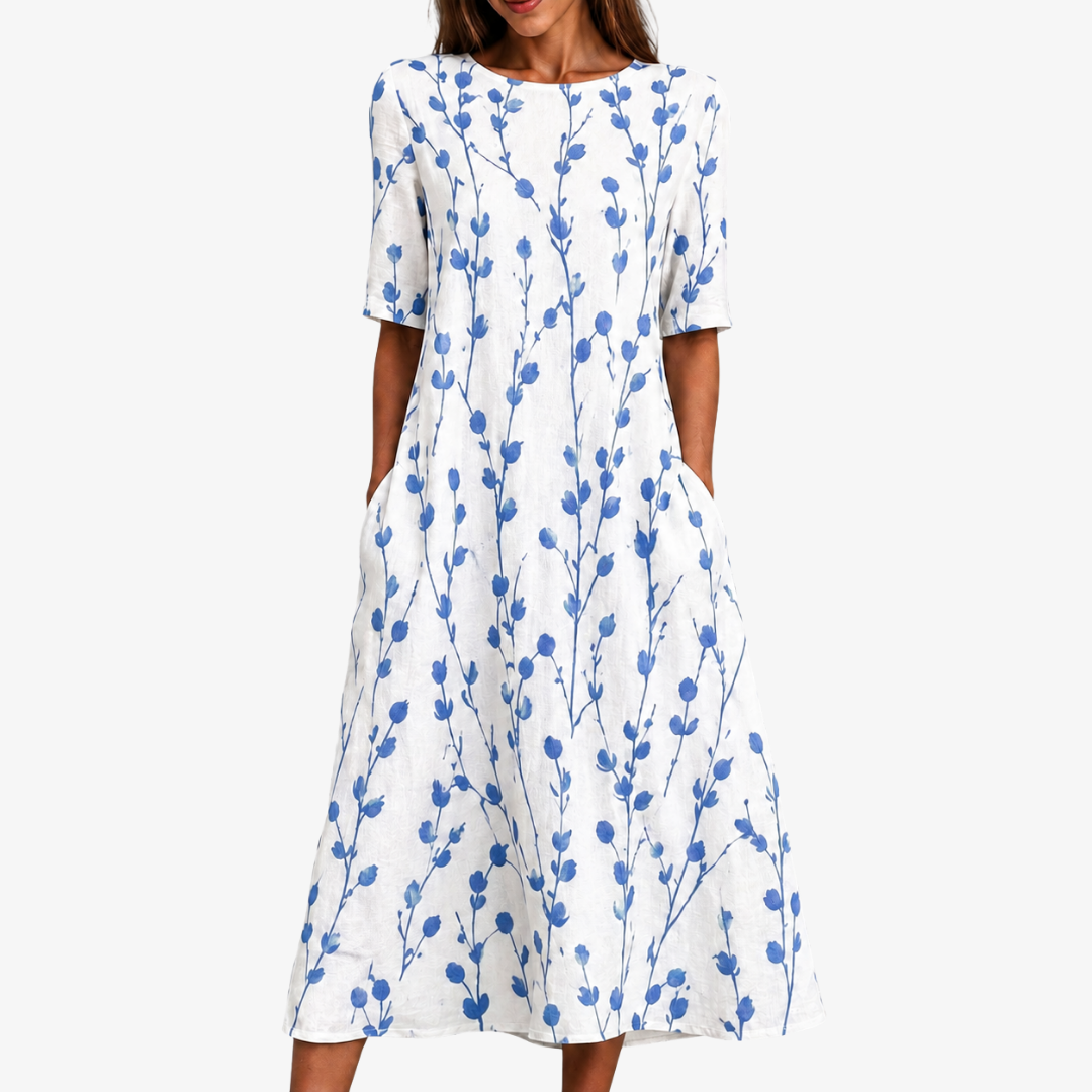 Women's blue floral midi dress with pockets. Elegant botanical print, perfect casual summer style.