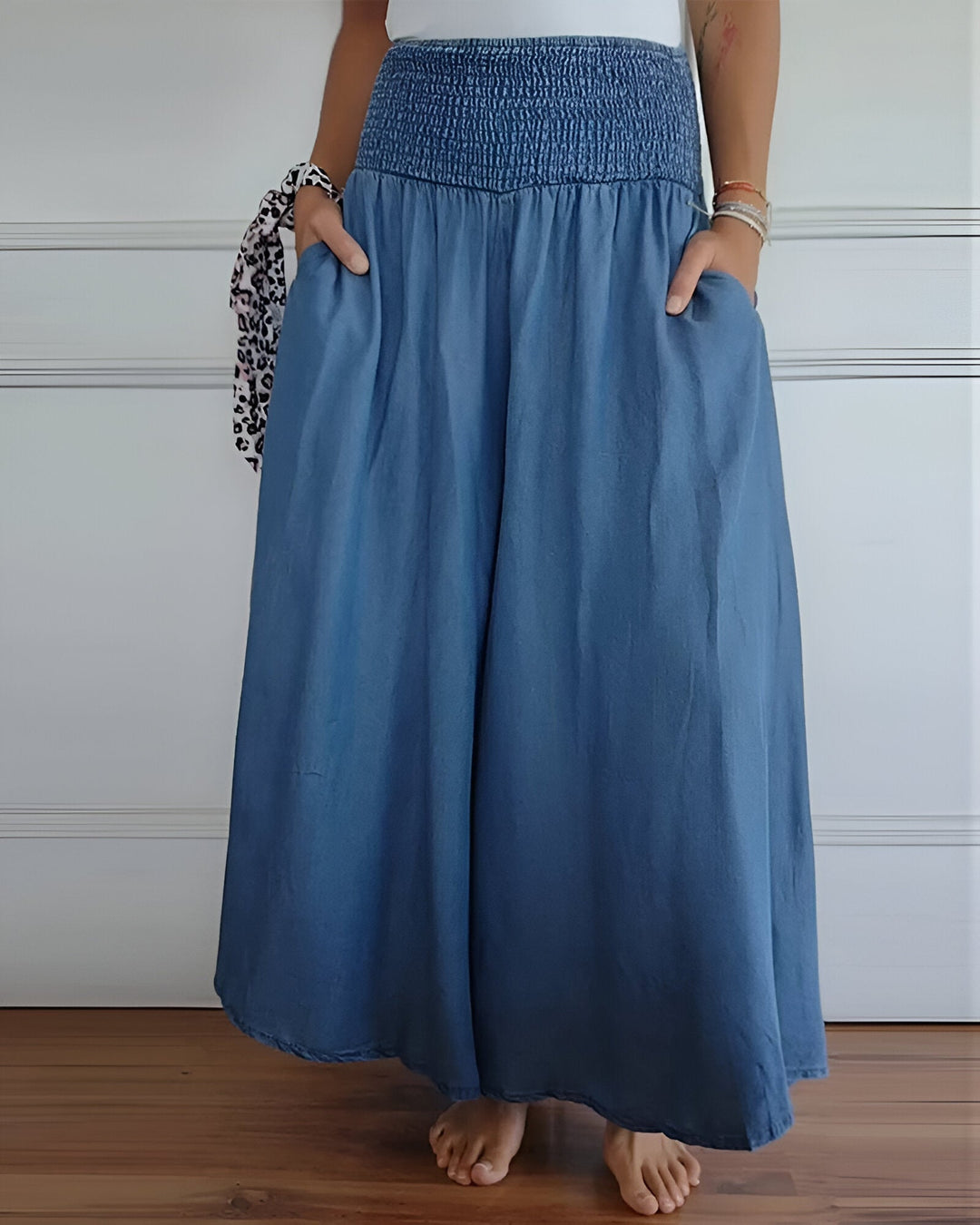 Women's blue maxi skirt with wide smocked waistband & flowing comfortable fabric. Perfect casual summer style.