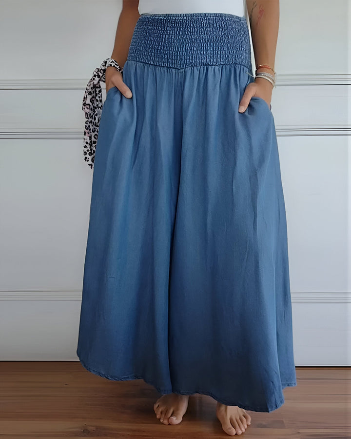 Women's blue maxi skirt with wide smocked waistband & flowing comfortable fabric. Perfect casual summer style.