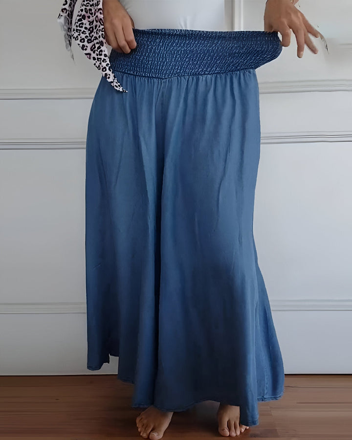 Versatile women's grey maxi skirt, featuring a wide smocked waist. Ideal for casual wear, comfortable & stylish.