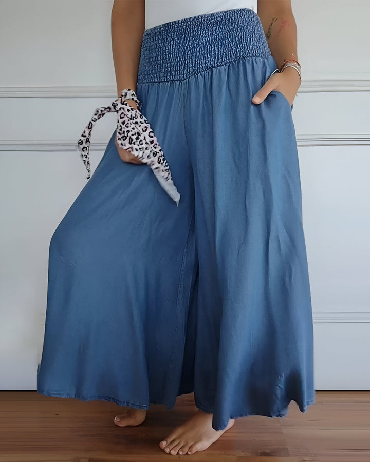 Flowing women's maxi skirt with wide smocked waistband & practical pockets. Comfortable summer casual wear.