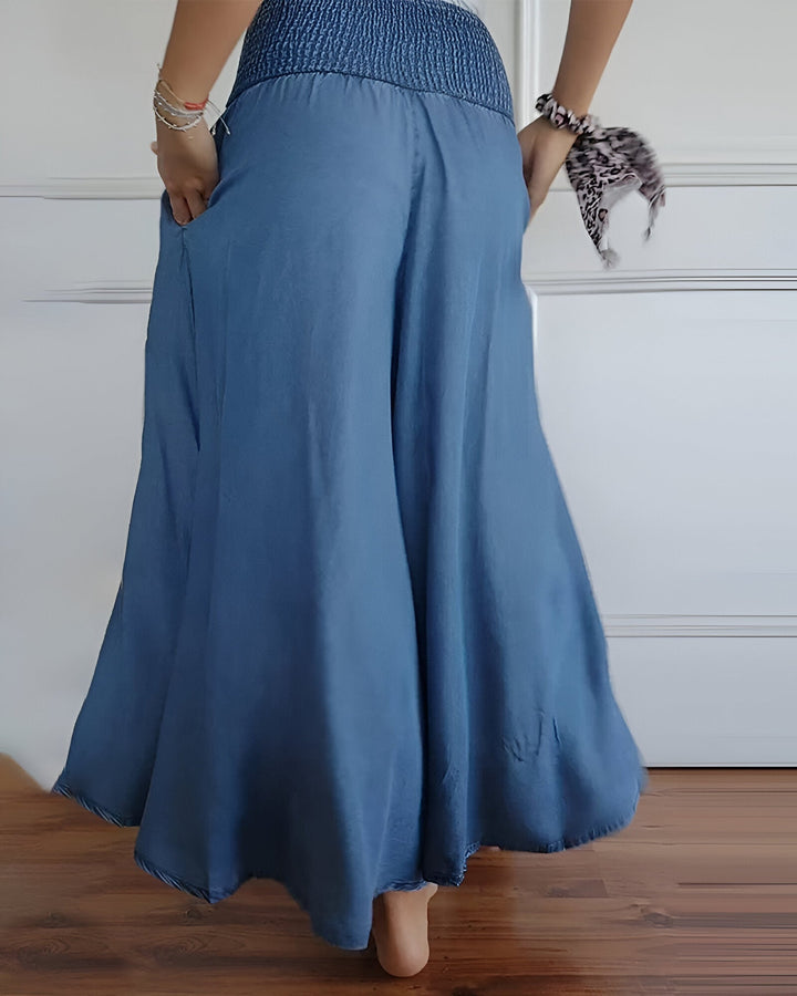 Comfortable blue women's maxi skirt, wide smocked waist, flowing fabric. Great for casual, everyday wear.
