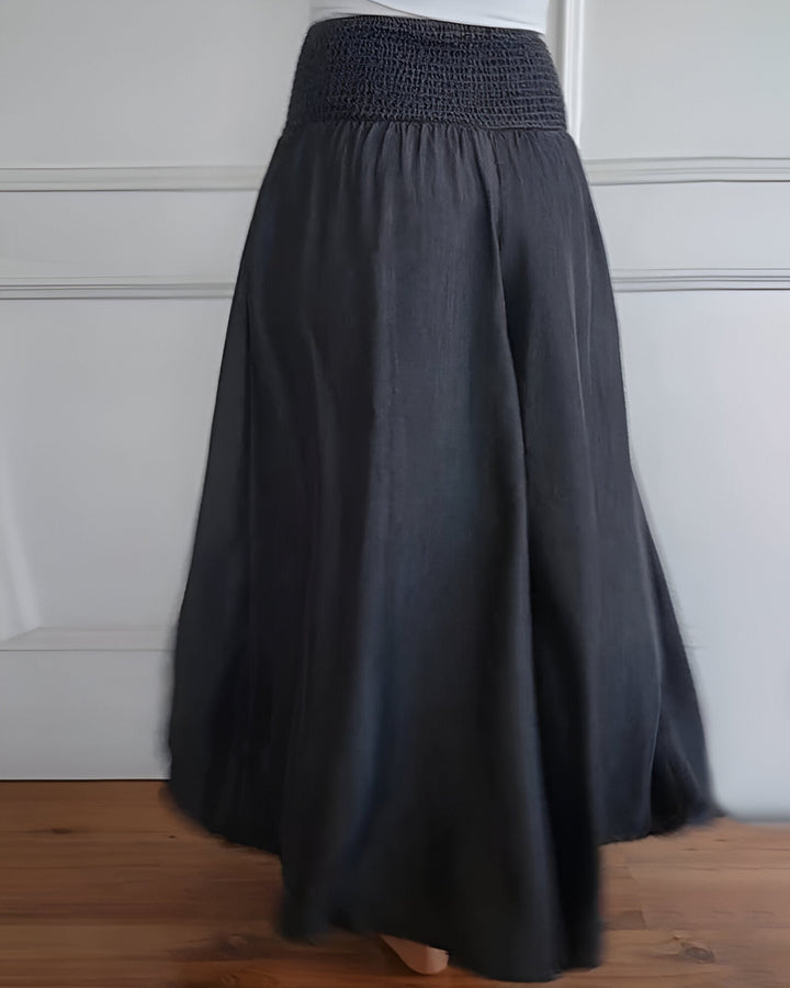 Grey casual maxi skirt for women, featuring a wide smocked waistband & flowing comfortable design. Summer ready.