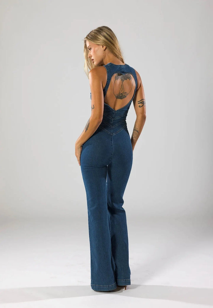 Blue women's fitted plunge neck jumpsuit with flared legs. Stylish one-piece for evening wear & streetwear.
