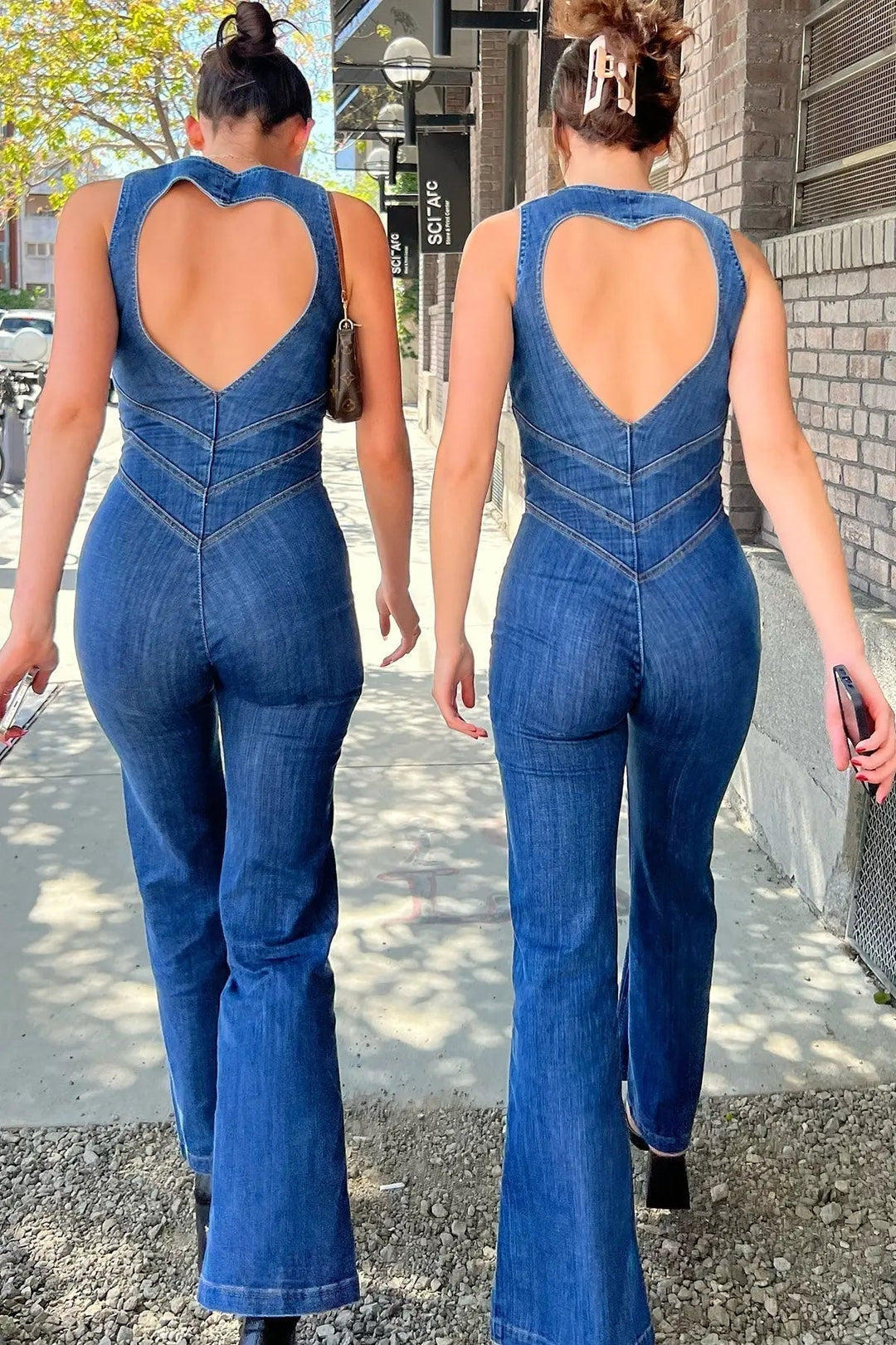 Fashionable women's sleeveless plunge neck jumpsuit. Fitted blue one-piece with trendy flared legs for streetwear.