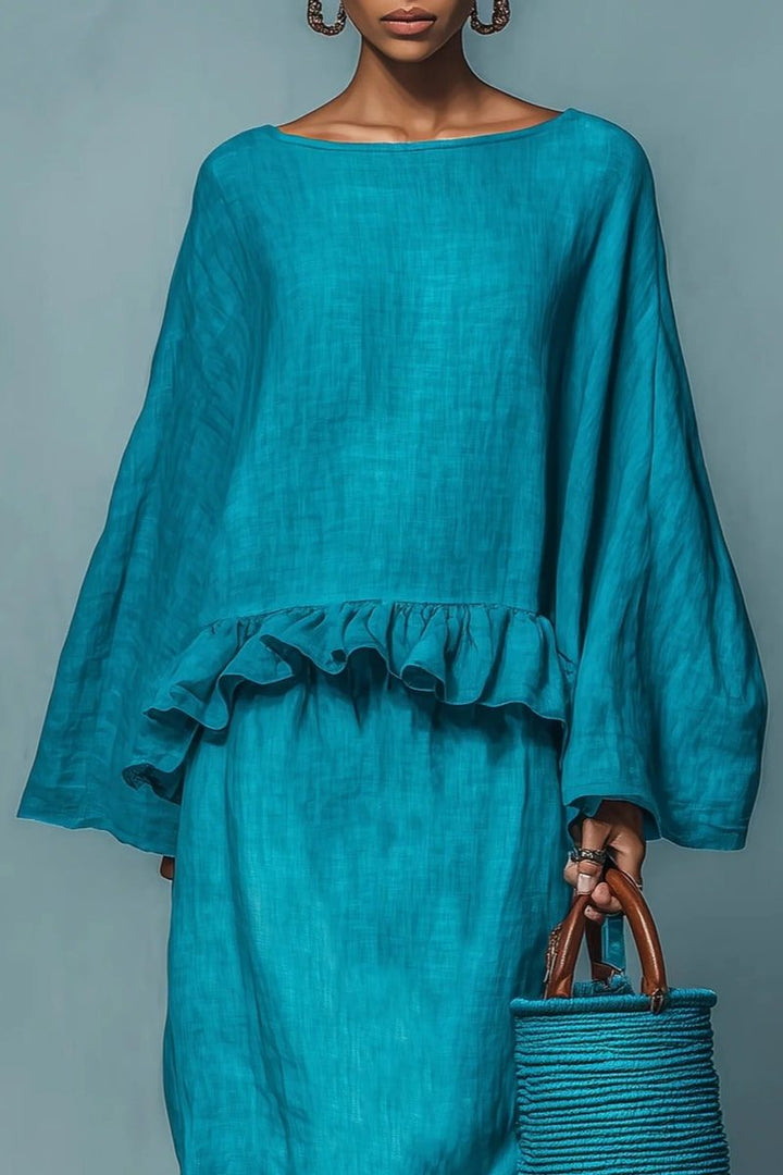 Coordinated two-piece women's blue ruffled maxi skirt and cape set, ideal for casual chic or travel wear.