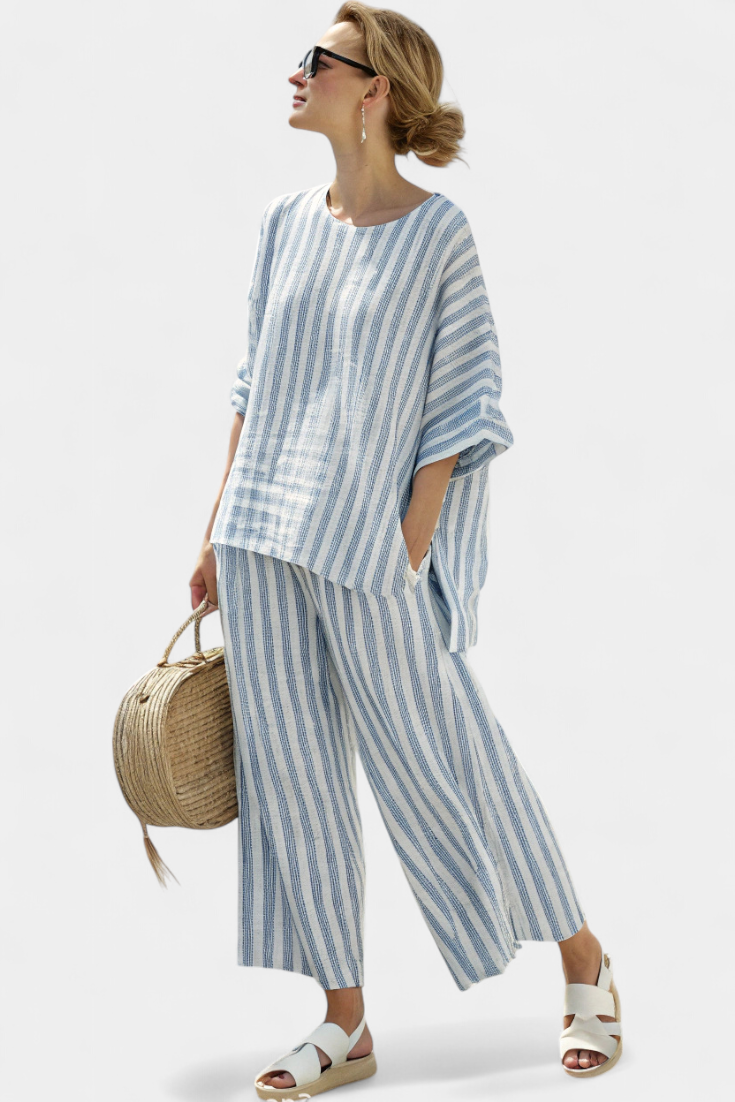 Elegant women's blue striped top and relaxed fit trousers, a stylish two-piece ensemble for any occasion.