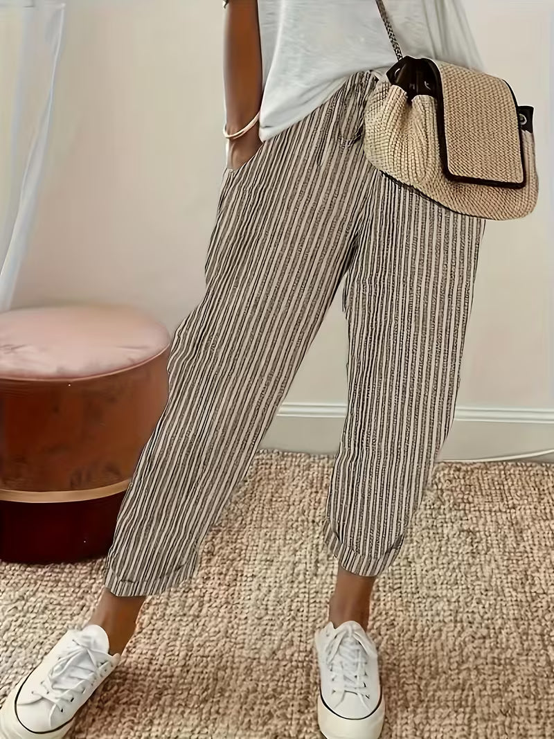 Stylish women's wide-leg striped trousers in blue, red, & white, ideal for comfortable summer fashion.