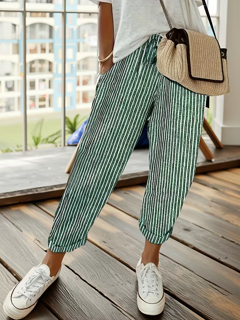 Comfortable women's striped wide-leg pants with elastic waist, offering a relaxed fit for casual wear.