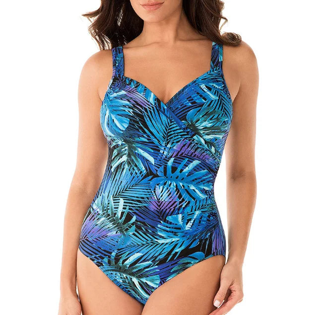 Elegant women's tropical leaf print V-neck swimsuit. Blue one-piece with tummy control, perfect for beach & poolside.