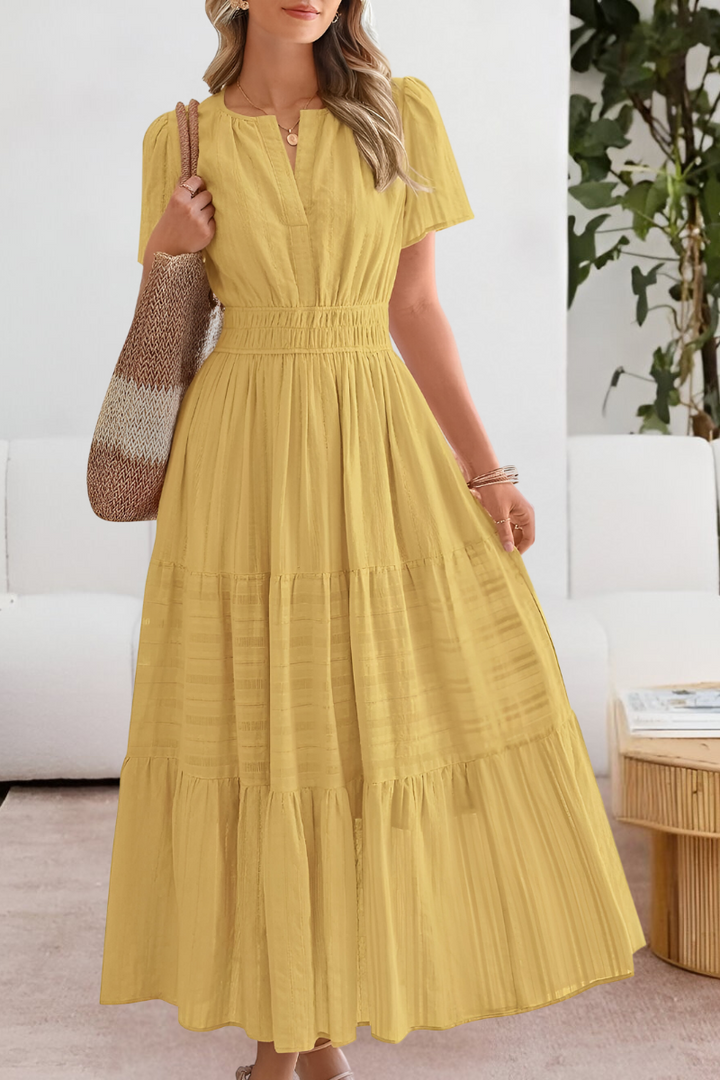 Women's bohemian midi dress with smocked bodice and short sleeves, perfect for summer casual style.