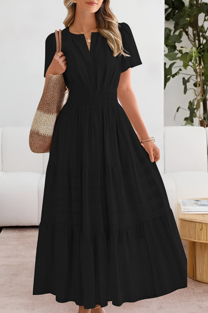Flowy boho midi dress for women featuring a comfortable smocked design and chic short sleeves.