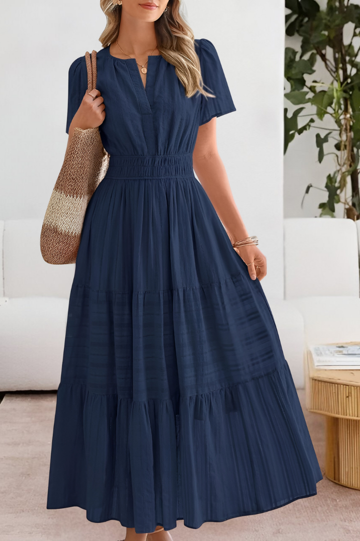 Casual women's smocked midi dress in a bohemian style, ideal for warm weather with short sleeves.