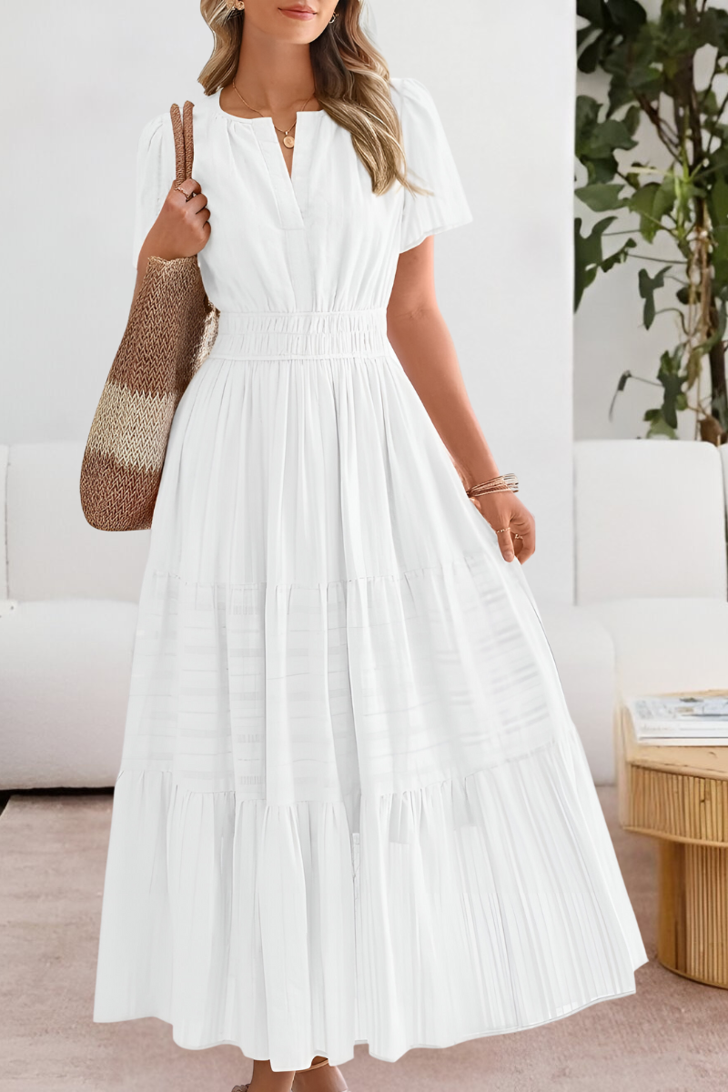 Elegant women's boho midi dress featuring a detailed smocked bodice, short sleeves, and flowy skirt.