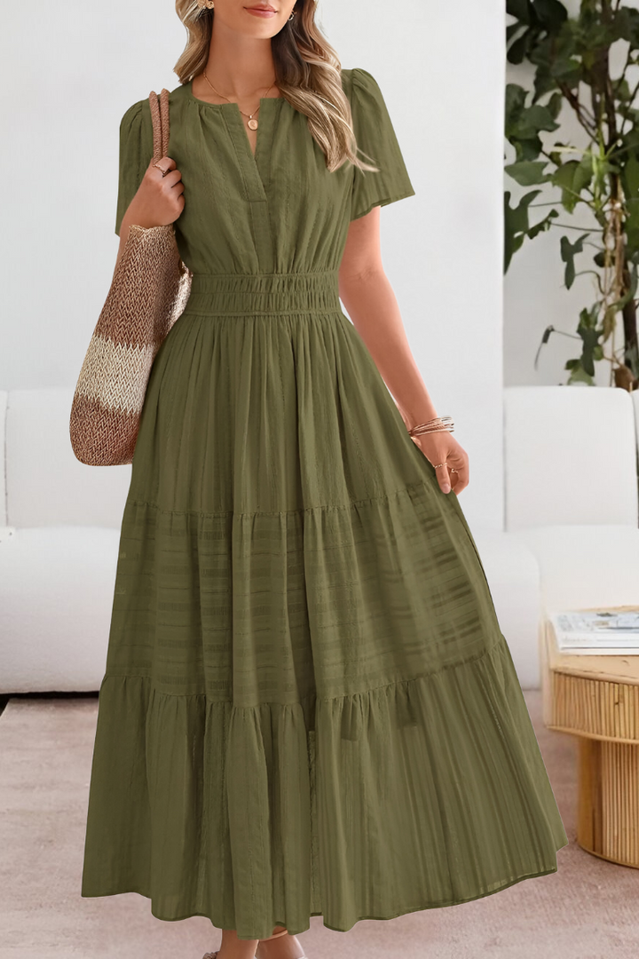 Lightweight women's bohemian midi dress, perfect for vacation, with smocked detail and short sleeves.
