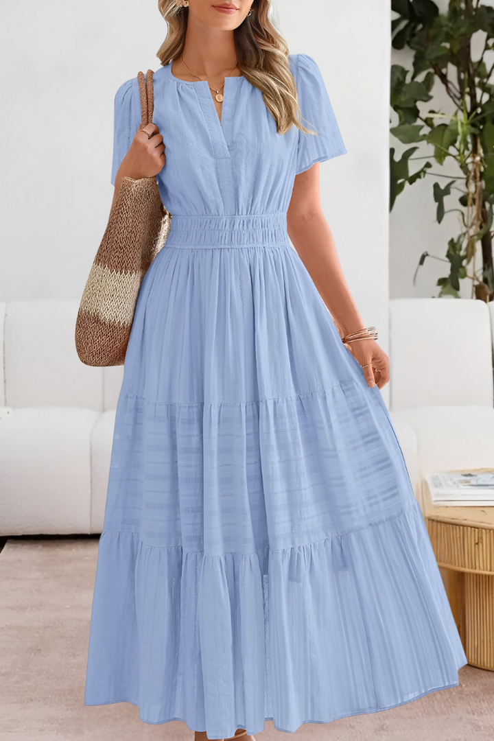 Chic women's smocked short sleeve midi dress, embracing a relaxed bohemian aesthetic for everyday comfort.