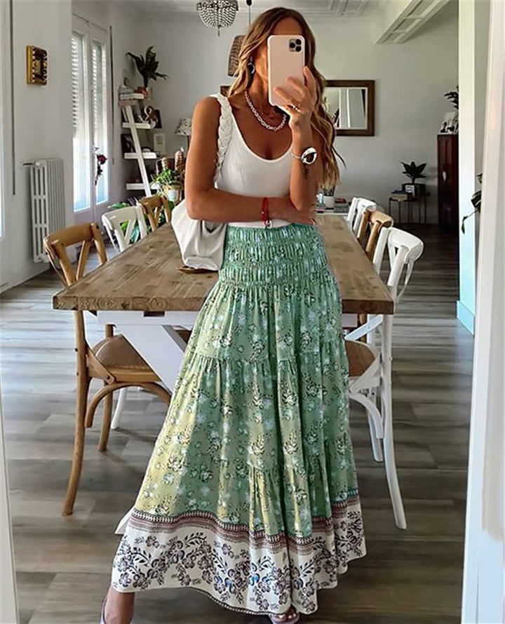 Elegant women's flowing bohemian midi skirt with tiered design & elastic waist, great for summer fashion.