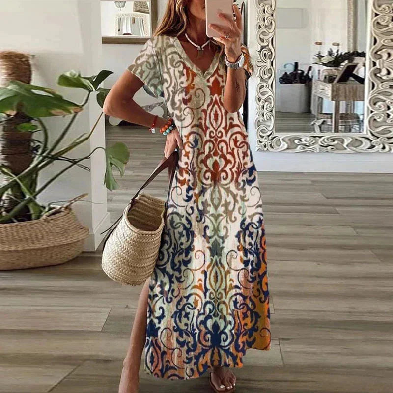 Women's bohemian V-neck maxi dress, vibrant floral print, short sleeves & flowy side split. Chic summer vacation style.
