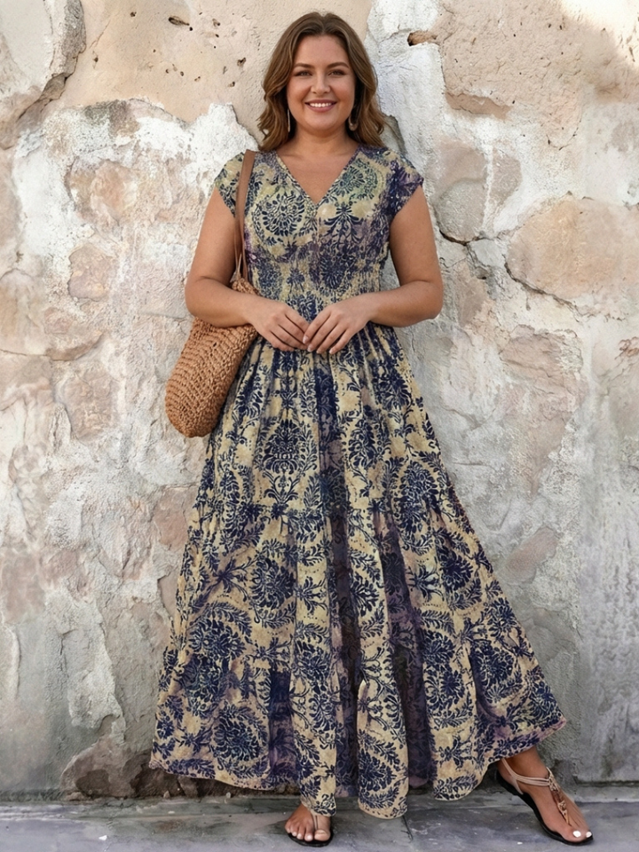 Flowy bohemian tiered maxi dress for women, featuring a stylish V-neck and cap sleeves, ideal for vacation.