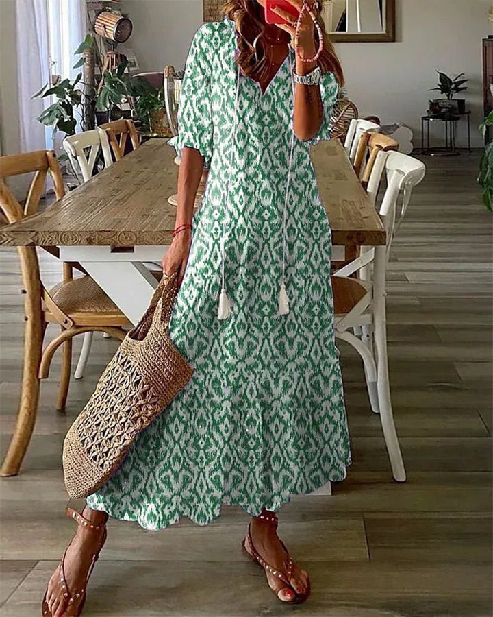 Effortless flowy bohemian midi dress for women, featuring a flattering V-neck, lantern sleeves & abstract print.