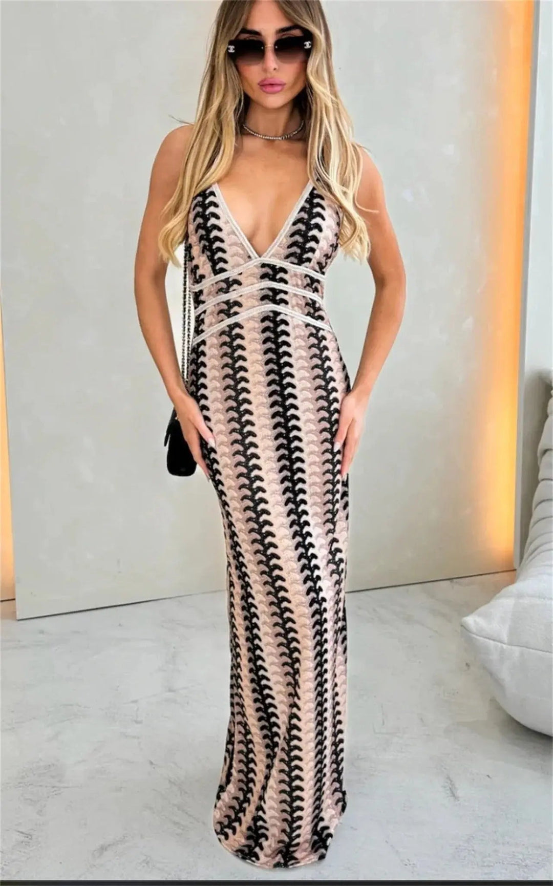 Hand-crocheted bohemian maxi dress with a halterneck design, ideal for a beach wedding or summer vacation.