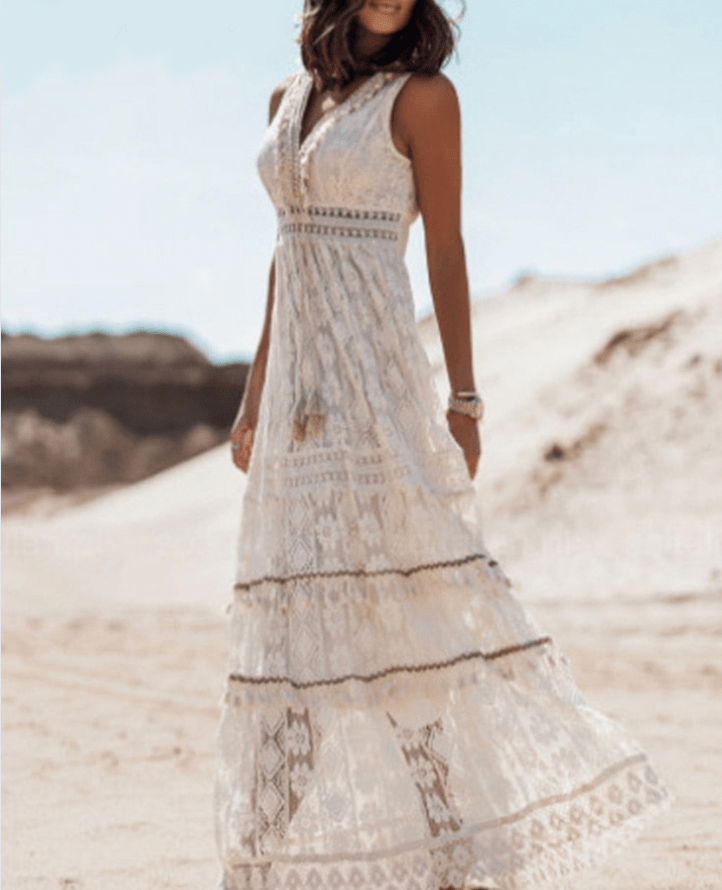 Bohemian women's relaxed fit crochet maxi dress, V-neck, fringe trim. Ideal casual or vacation summer wear.