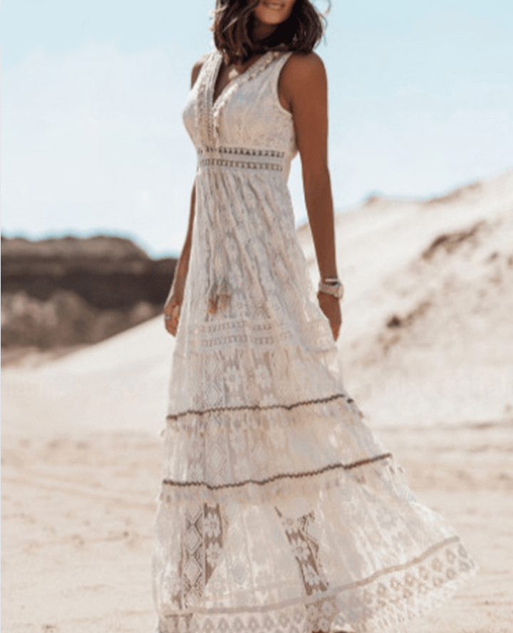 Bohemian women's relaxed fit crochet maxi dress, V-neck, fringe trim. Ideal casual or vacation summer wear.