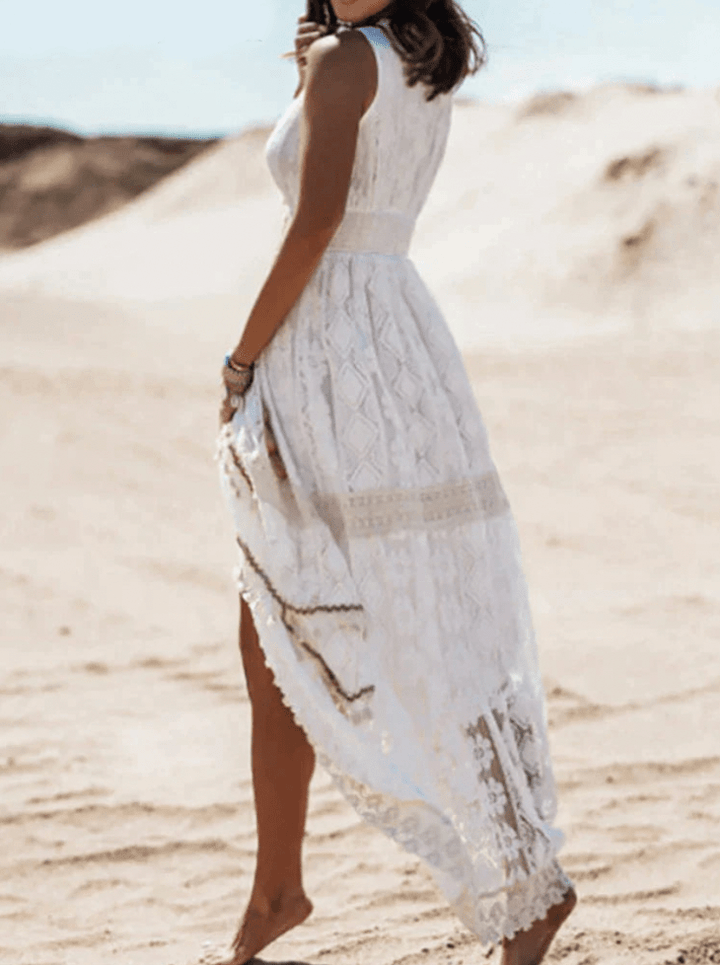 Chic women's bohemian crochet maxi dress with fringe, V-neck. Versatile for beach, festival, or vacation outfits.
