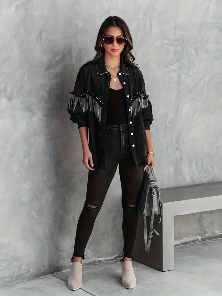 Women's boho denim jacket with chic fringe and stud details, perfect for festival wear or a casual bohemian look.