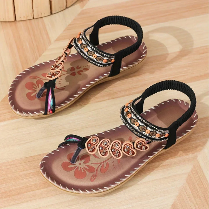 Flat women's boho floral embellished sandals with a secure slingback strap, ideal for beach footwear.