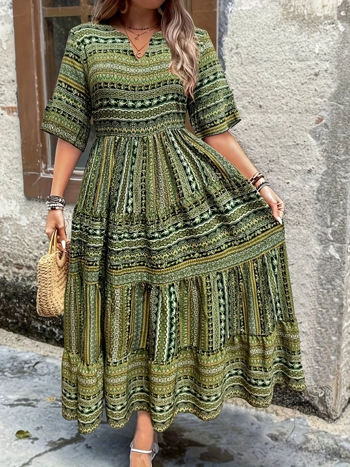 Elegant women's bohemian maxi dress with print, V-neck, and flutter sleeves for vacation wear.