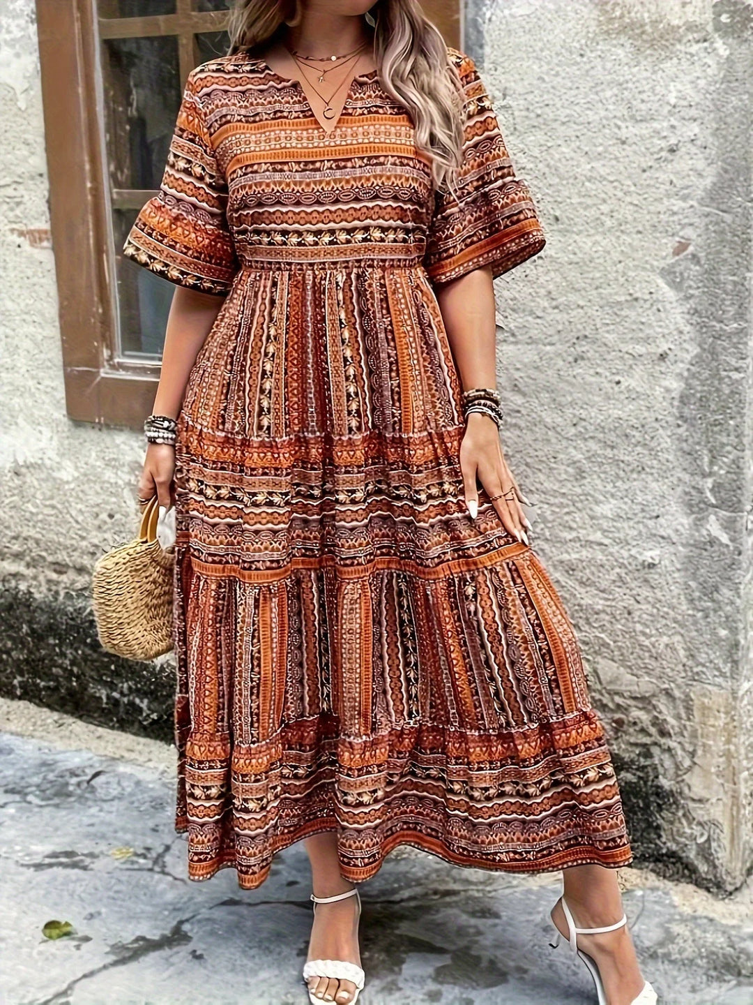 Printed V-neck women's long boho dress featuring graceful flutter sleeves and a relaxed fit.
