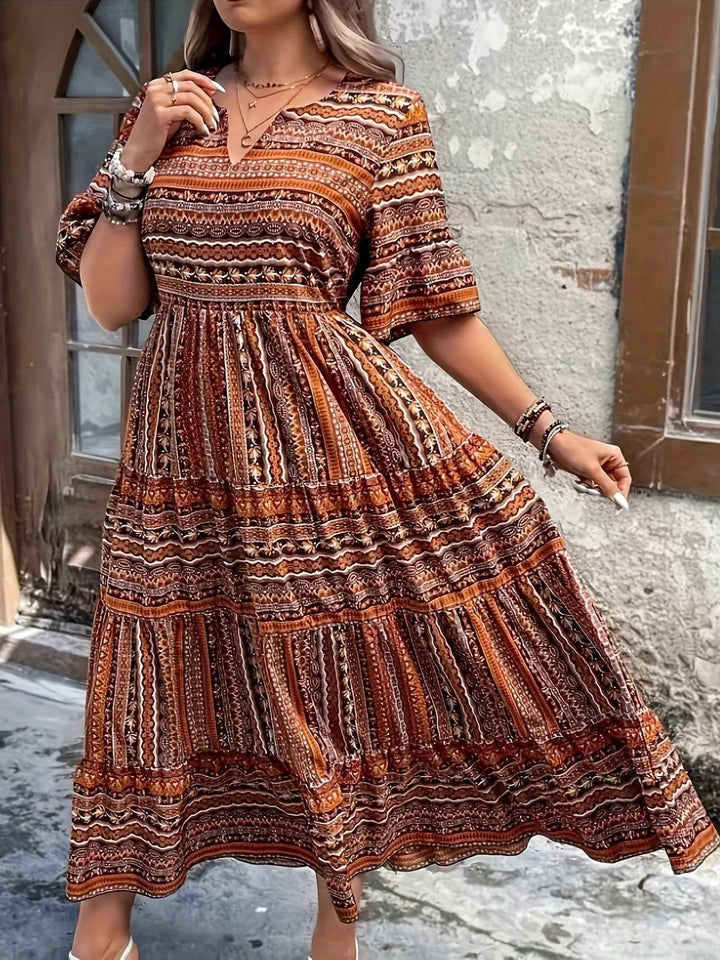 Chic women's bohemian V-neck maxi dress with flutter sleeves, a trendy flowy summer fashion piece.