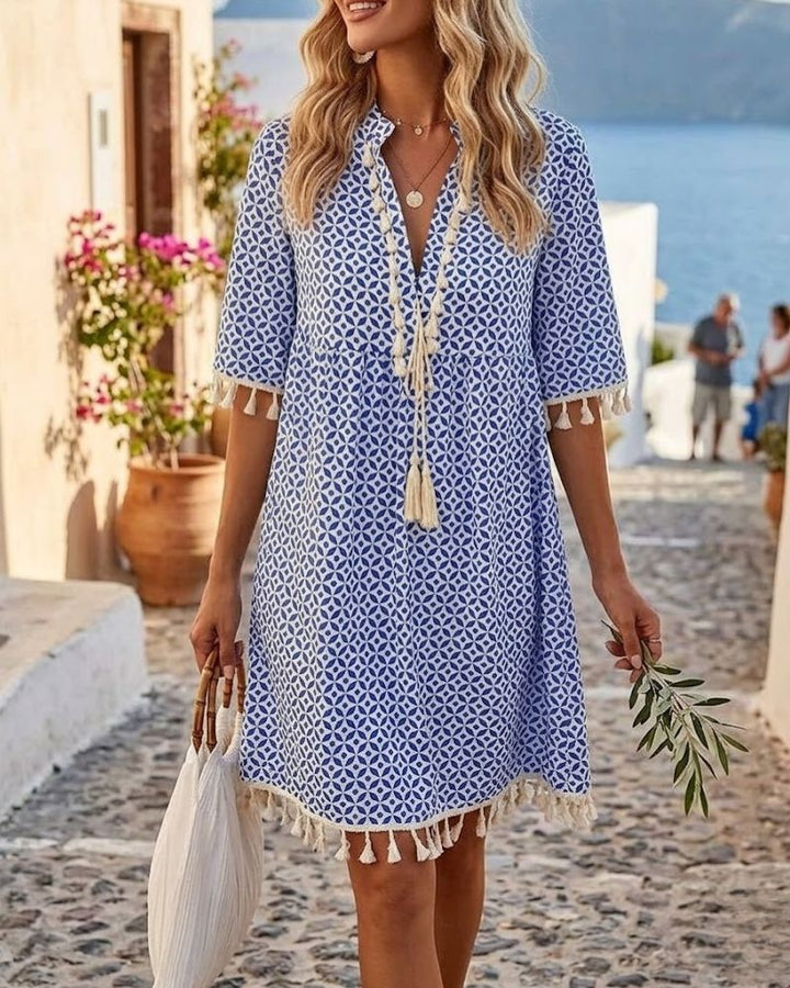 Women's boho geometric print mini tunic dress with V-neck, perfect for summer casual or resort wear.