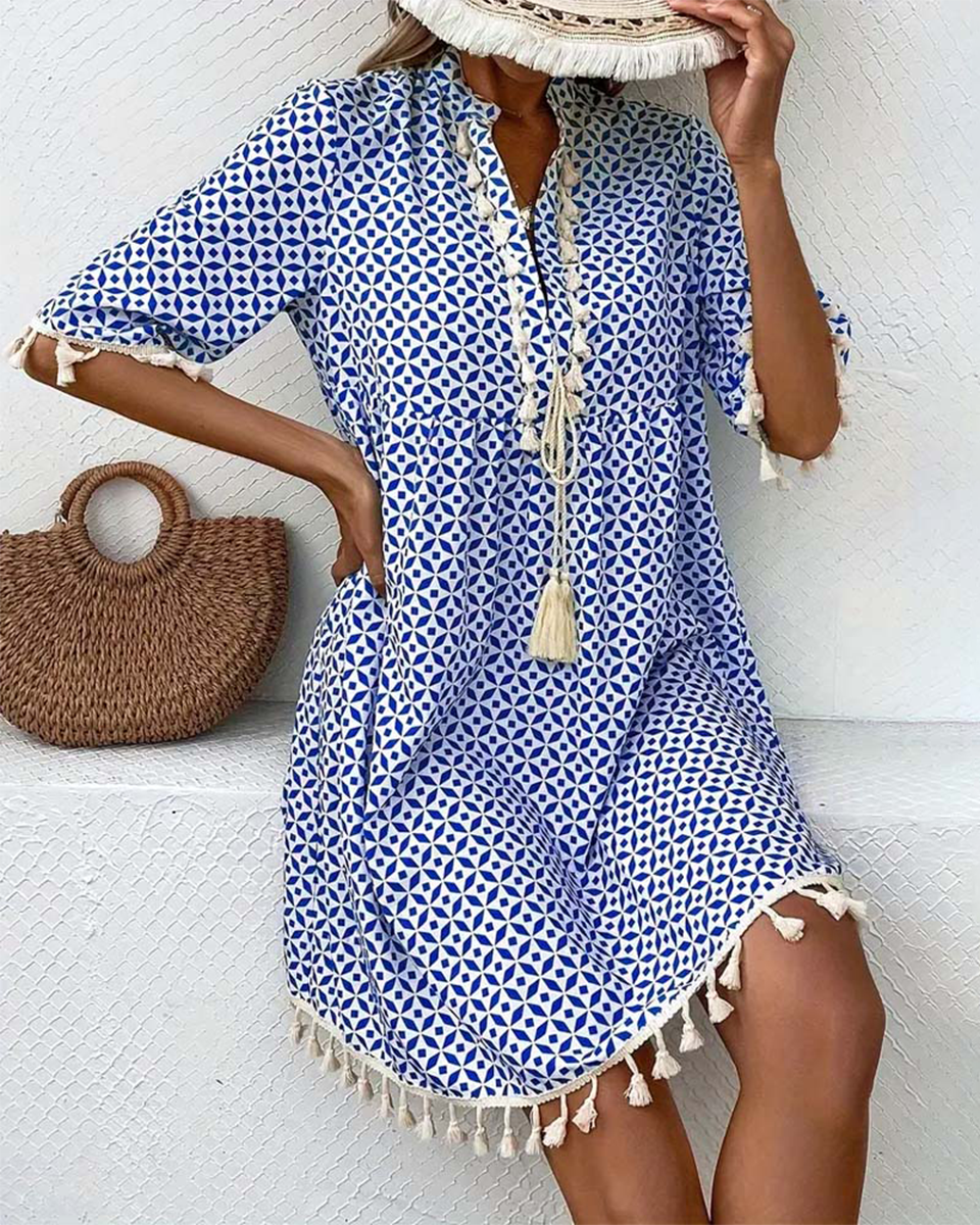 Boho geometric print mini tunic dress for women, featuring a stylish V-neck and playful tassel details.