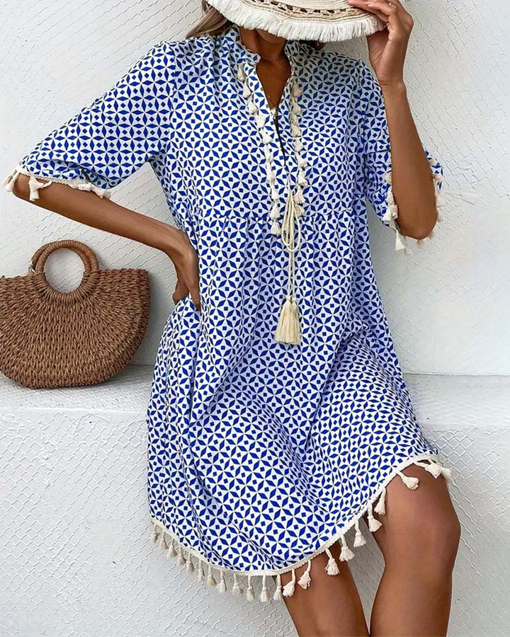 Boho geometric print mini tunic dress for women, featuring a stylish V-neck and playful tassel details.