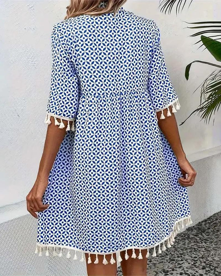 Vibrant geometric print mini tunic dress for women, offering a relaxed boho fit, perfect for warm weather fashion.