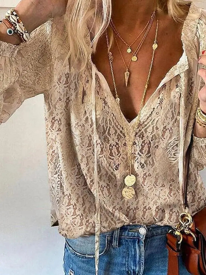 Women's boho lace blouse with deep V-neck and long sleeves, perfect for a bohemian look.